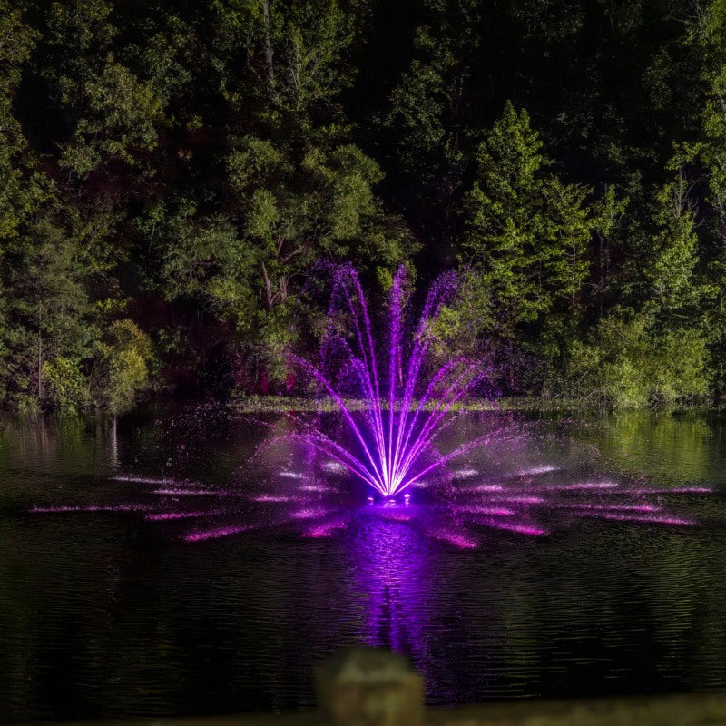 Kasco RGBW LED Lighting - RGBW18 LED Lighting System illuminating a wide-pattern fountain in purple at night