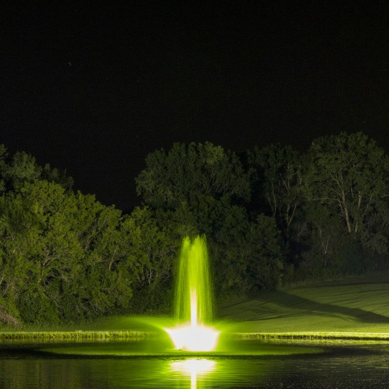 Kasco RGBW LED Lighting - RGBW18 LED Lighting System lighting a pond fountain in vibrant green at night
