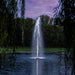 Kasco RGBW LED Lighting - W25 White LED Lighting System illuminating a pond fountain at dusk framed by trees