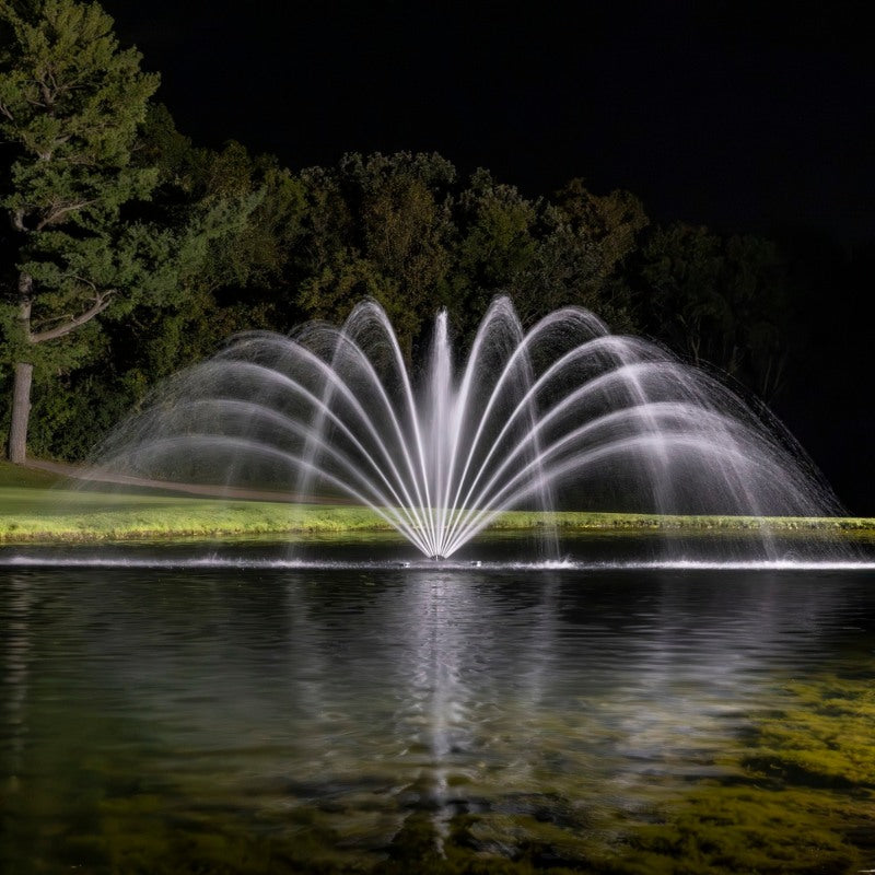 Kasco RGBW LED Lighting - W25 White LED Lighting System illuminating a wide arc fountain pattern at night