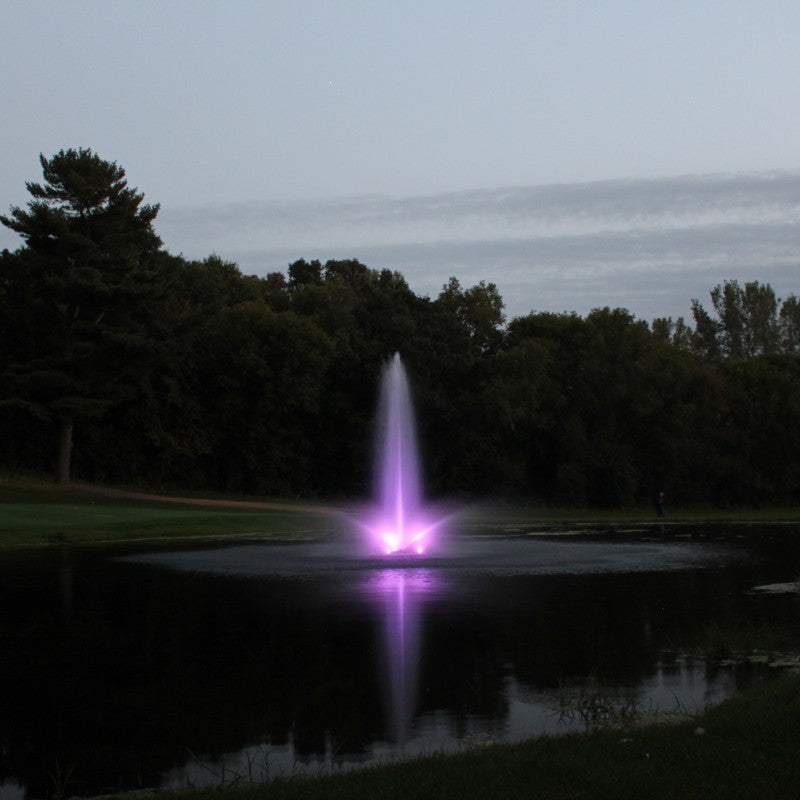 Kasco RGB LED Lighting illuminating a vertical pond fountain with purple light during dusk