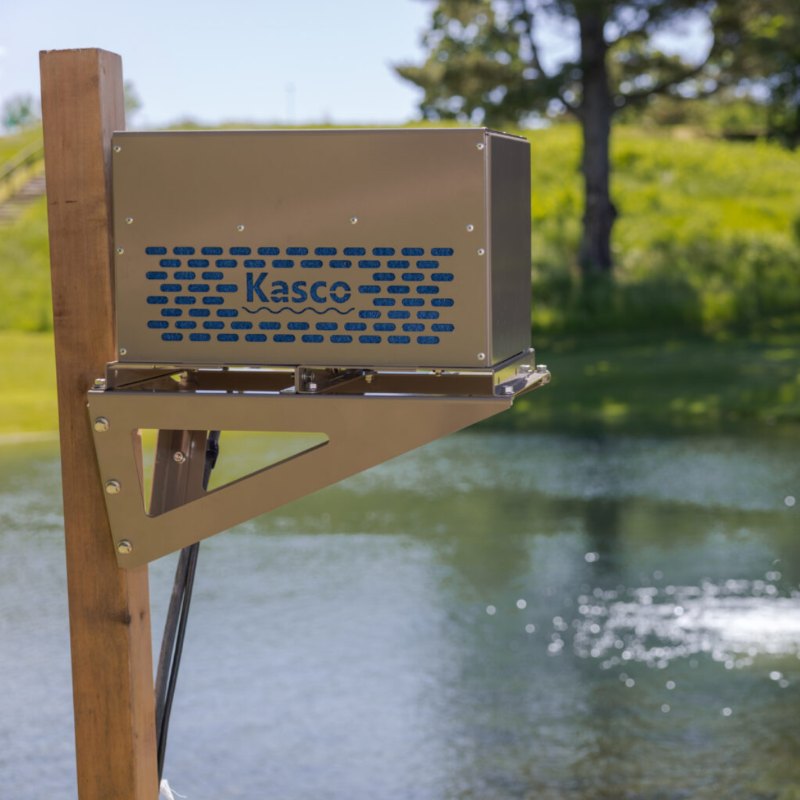 Kasco Robust-Aire Diffused Aeration System - Small Cabinet with Post Mount Bracket on a wooden stand by a pond