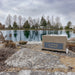 Kasco Robust Aire compressor cabinet installed beside pond shoreline with lake and trees in background