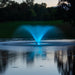 Kasco VFX Aerating Fountain glowing with blue LED lighting, creating a vibrant nighttime water display