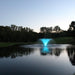 Kasco VFX aerating fountain with teal LED lighting in pond at dusk