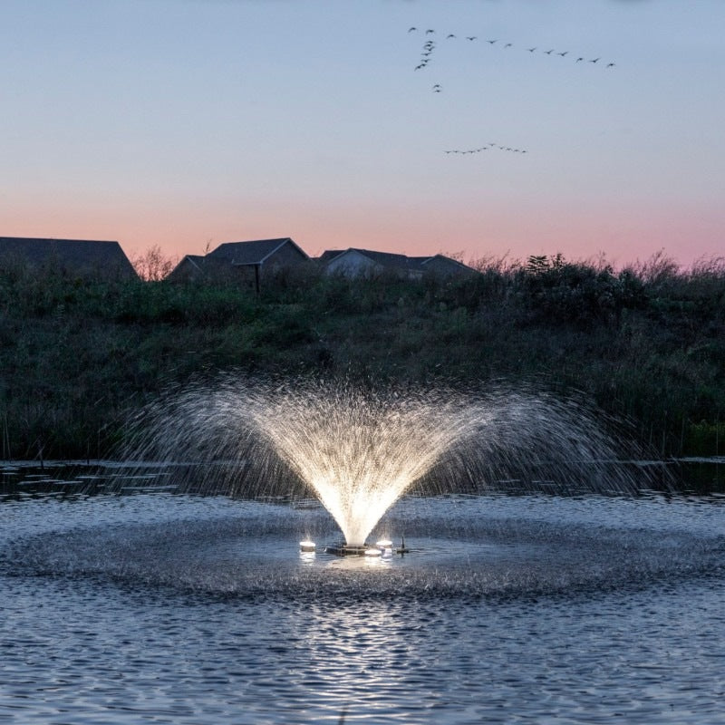 Kasco VFX aerating fountain with warm white LED lights illuminating spray pattern
