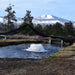 Kasco surface aerator operating in a small pond with snow-covered mountains in the background during cold weather conditions