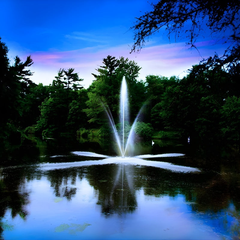 SCOTT AERATOR Clover Fountain in a pond surrounded by trees at dusk