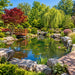 Savio Pond Packages large landscaped koi pond with waterfall, wooden bridge, rocks, trees, and aquatic plants