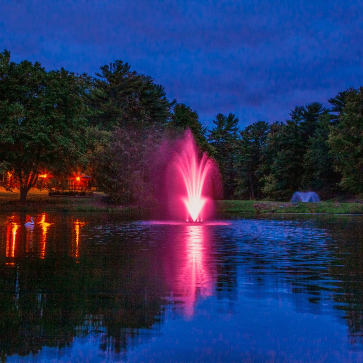 Scott Aerator Amherst Fountain Masterpiece Bundle – The fountain is on display in the water with a red LED light during nighttime
