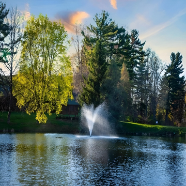 Scott Aerator Millbrook Nozzle - Spray Pattern On Water Display with Trees at the Background