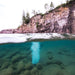 Split waterline view of Kasco Robust Aire diffuser operating beneath lake surface with visible bubble column