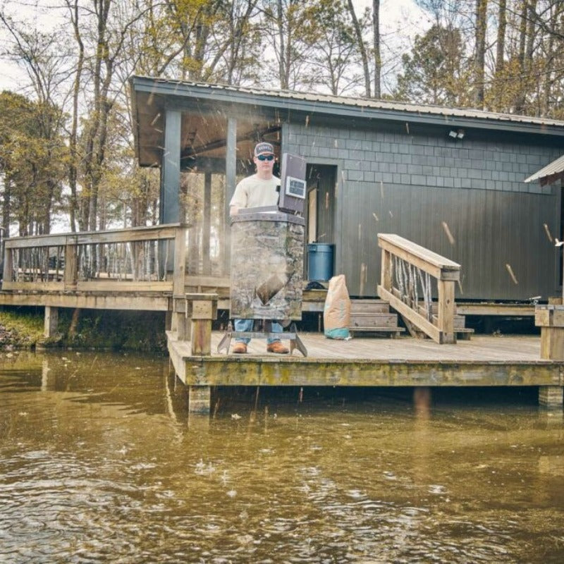 Texas Avenger Fish Feeder - A man feeding fish at the pond using the feeder