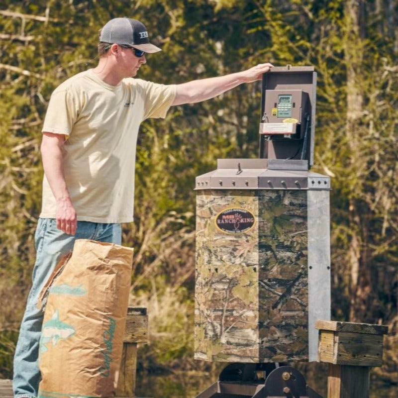 Texas Avenger Fish Feeder - A man is filling up the feeder
