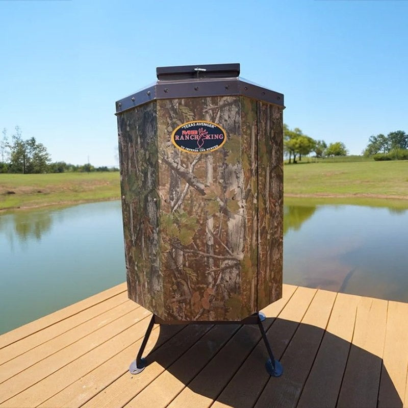 Texas Avenger Fish Feeder - Showing the 250 lbs fish feeder beside the pond