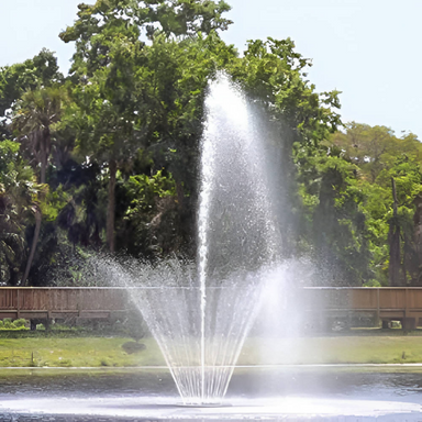 Vertex RingJet Floating Fountain Series On Water with Trees at the Background