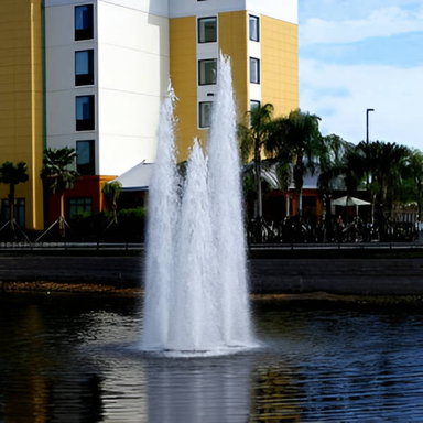 Vertex TriGeyser Floating Fountain Series On Water with Buildings at the Background