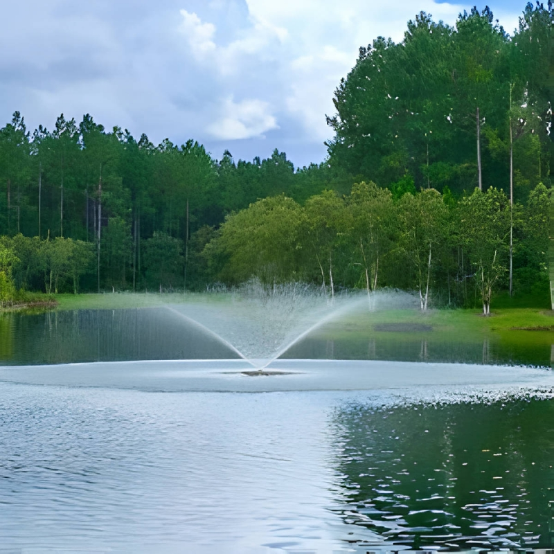 Vertex Vertical FunnelJet Fountain - On Water with Trees at the Background