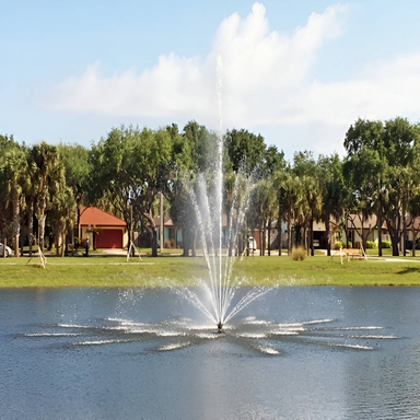 Vertex Vertical TriTier Fountain - On Water Display with Trees and Structures at the Background
