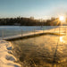Winter dock with open water area around pier at sunrise demonstrating ice prevention using Kasco De-Icer
