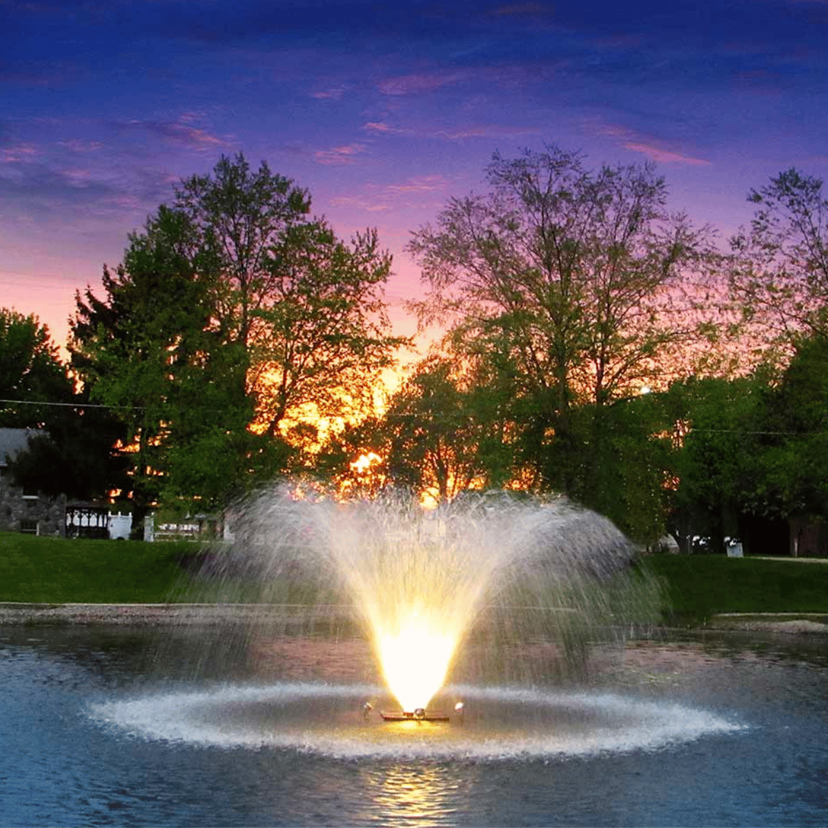 Night Glo LED Residential Fountain Lights - On Water Display with Trees at the Background